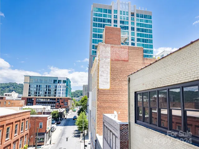 a kitchen with kitchen island granite countertop a sink and a white cabinets