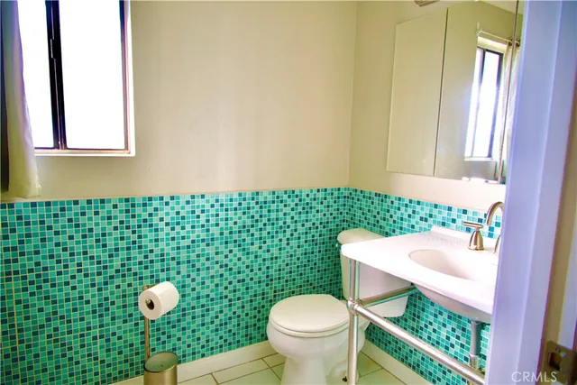 a bathroom with a sink toilet and mirror