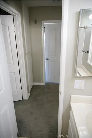 a view of a bathroom from a hallway