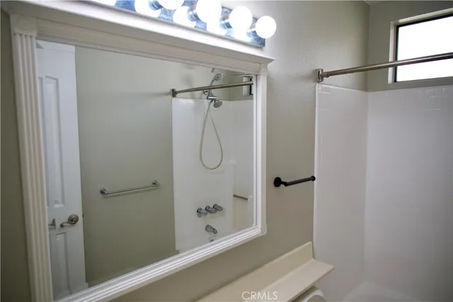 a bathroom with a glass shower door