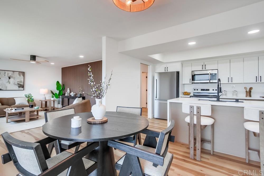 3606 Vista Rey, Unit 37 Oceanside, CA 92057 - Photo 8 of 45 a kitchen with stainless steel appliances a dining table chairs and granite counter tops