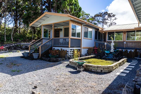 a front view of a house with swimming pool and porch
