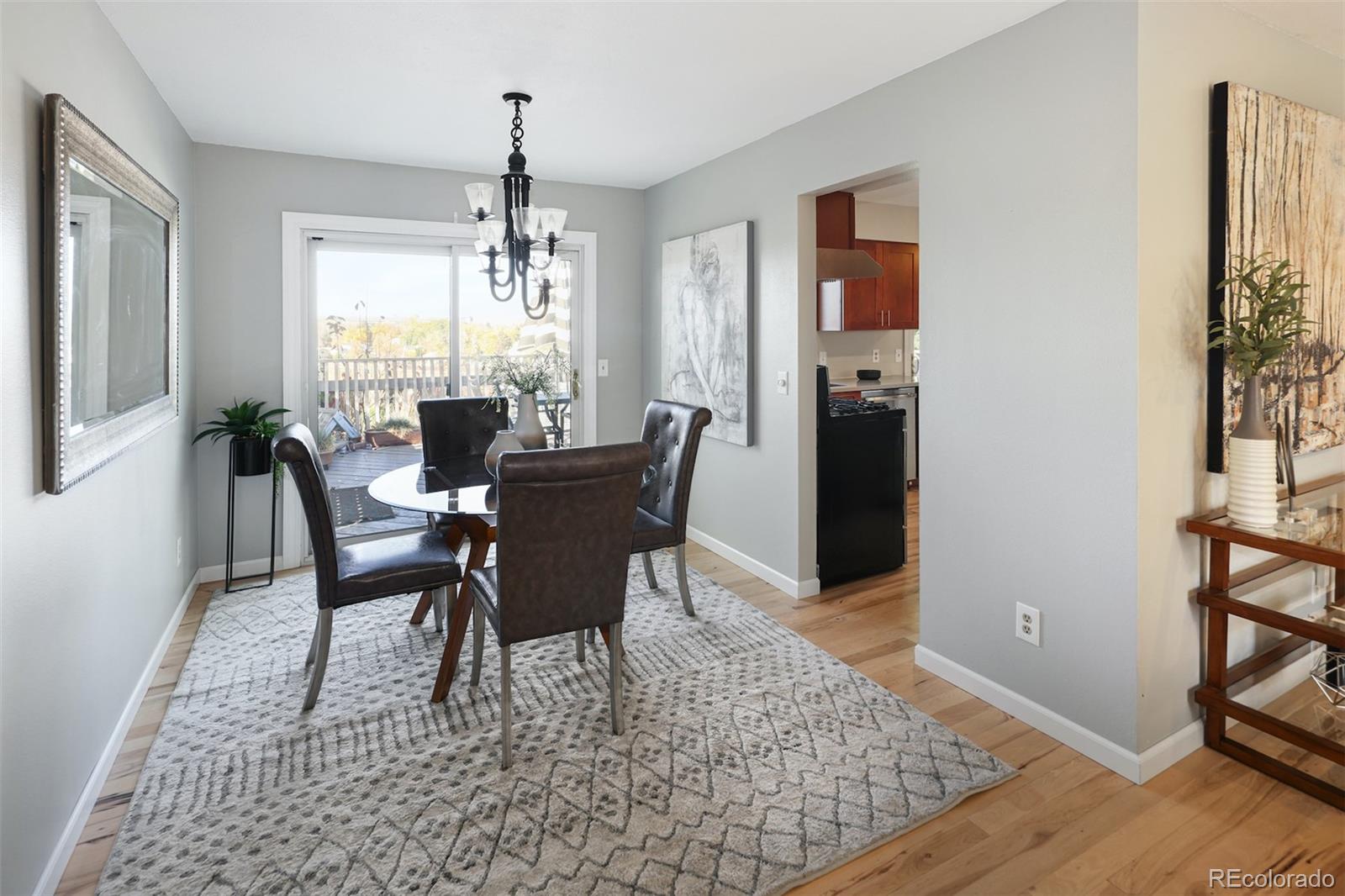 10499 Newcombe Street Westminster, CO 80021 - Photo 11 of 33 a dining room with furniture window entryway and wooden floor