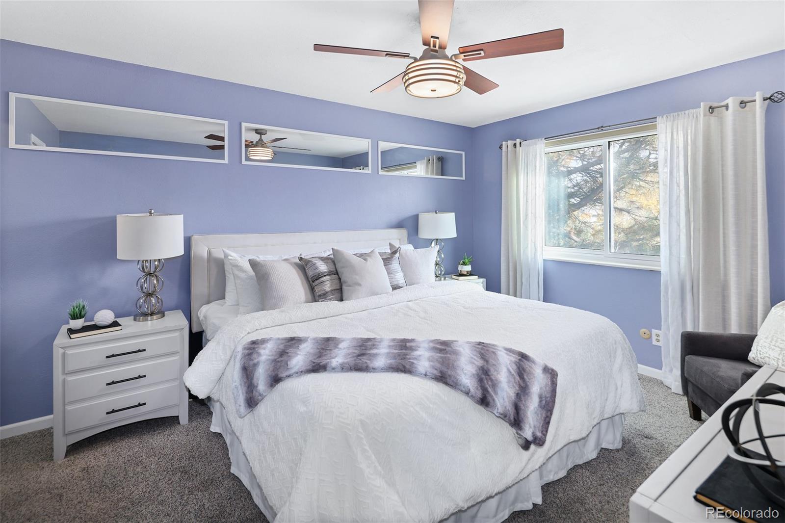 10499 Newcombe Street Westminster, CO 80021 - Photo 19 of 33 a bedroom with a bed a chandelier and a dresser