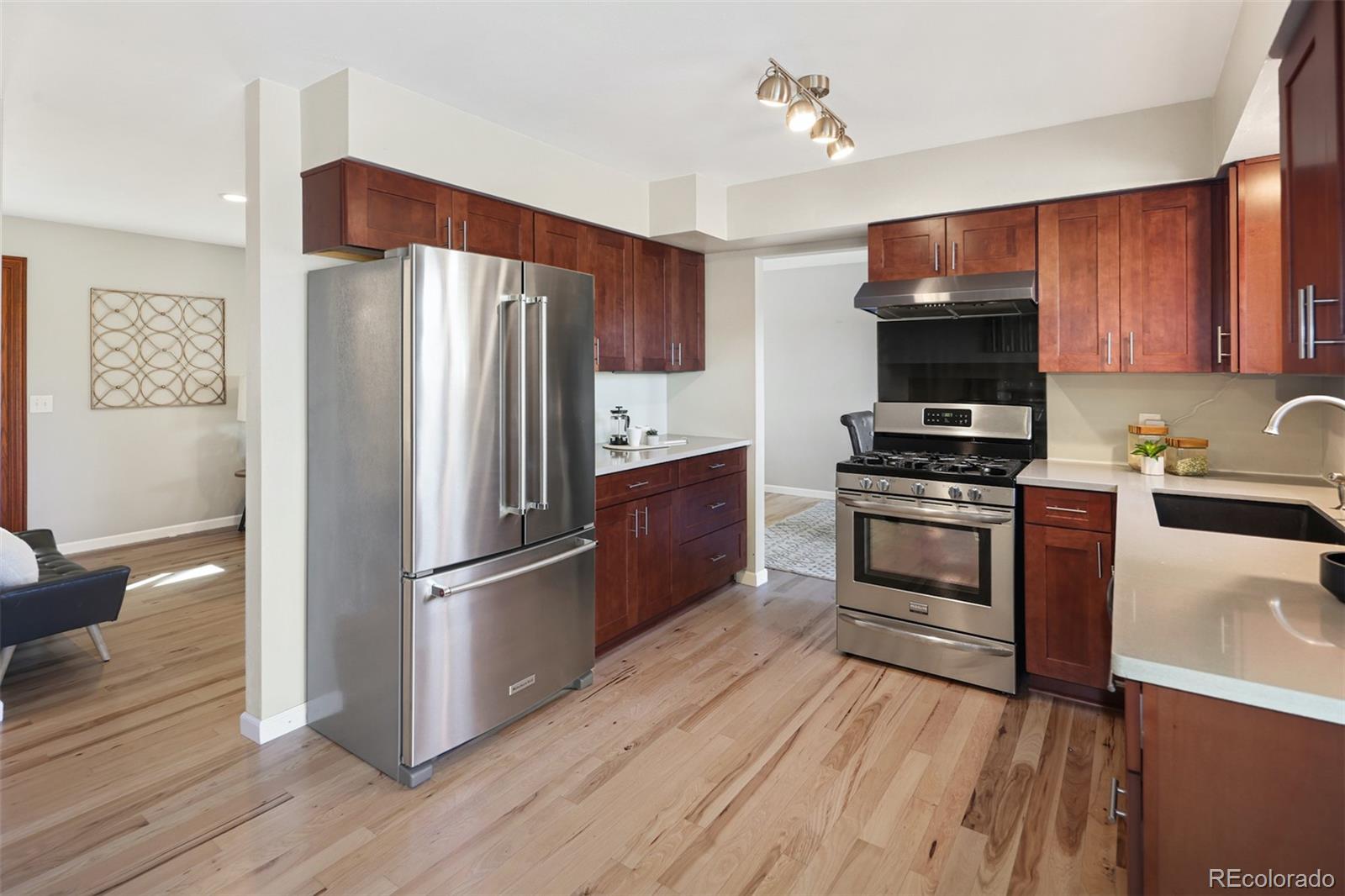 10499 Newcombe Street Westminster, CO 80021 - Photo 2 of 33 a kitchen with stainless steel appliances a refrigerator stove and microwave