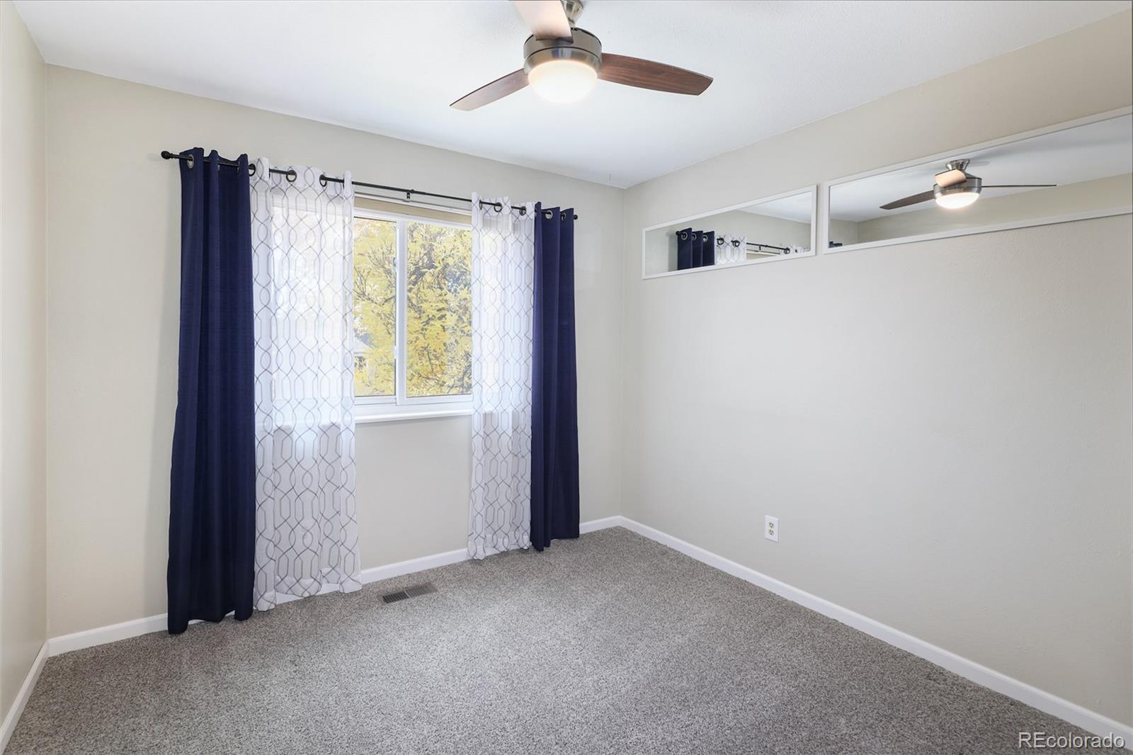 10499 Newcombe Street Westminster, CO 80021 - Photo 23 of 33 a view of an empty room with a window