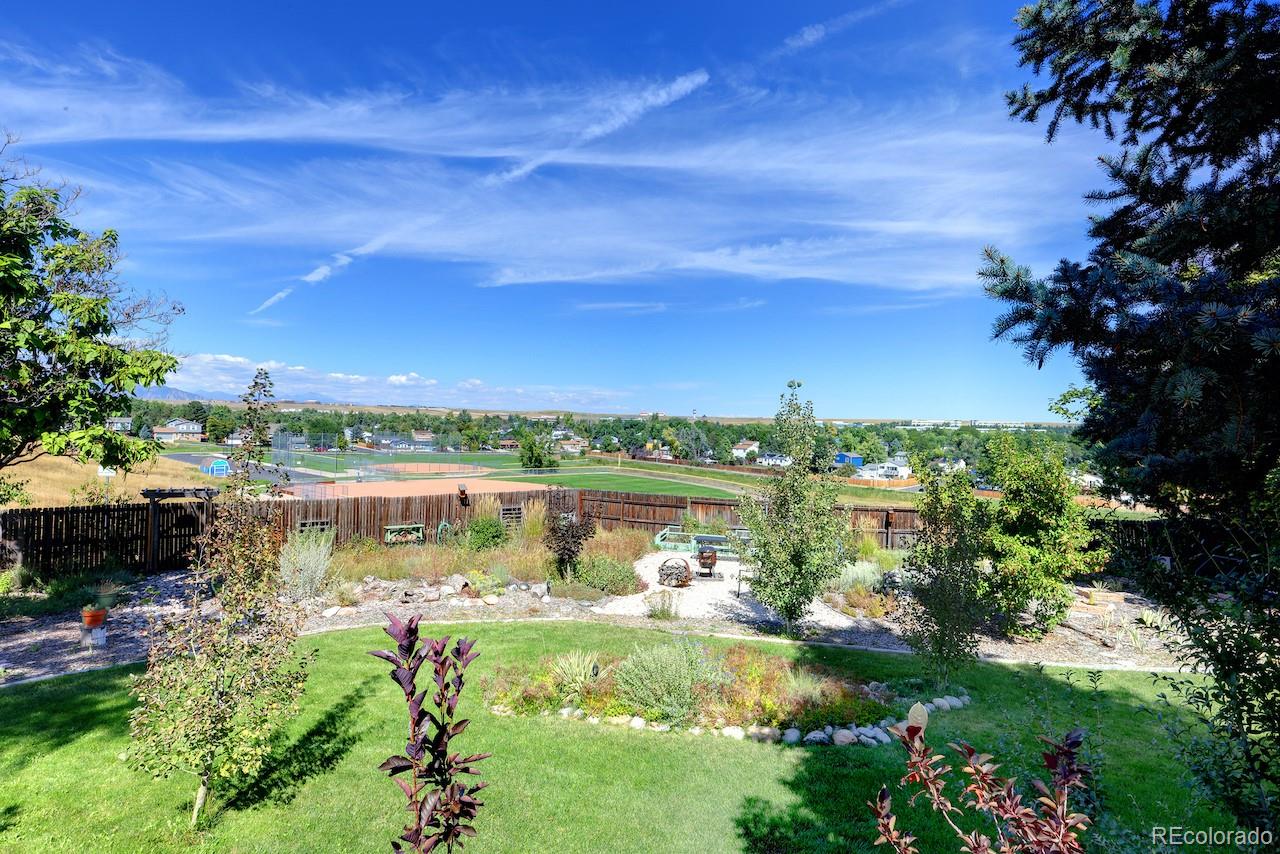 10499 Newcombe Street Westminster, CO 80021 - Photo 31 of 33 a view of a lake with a house in the background