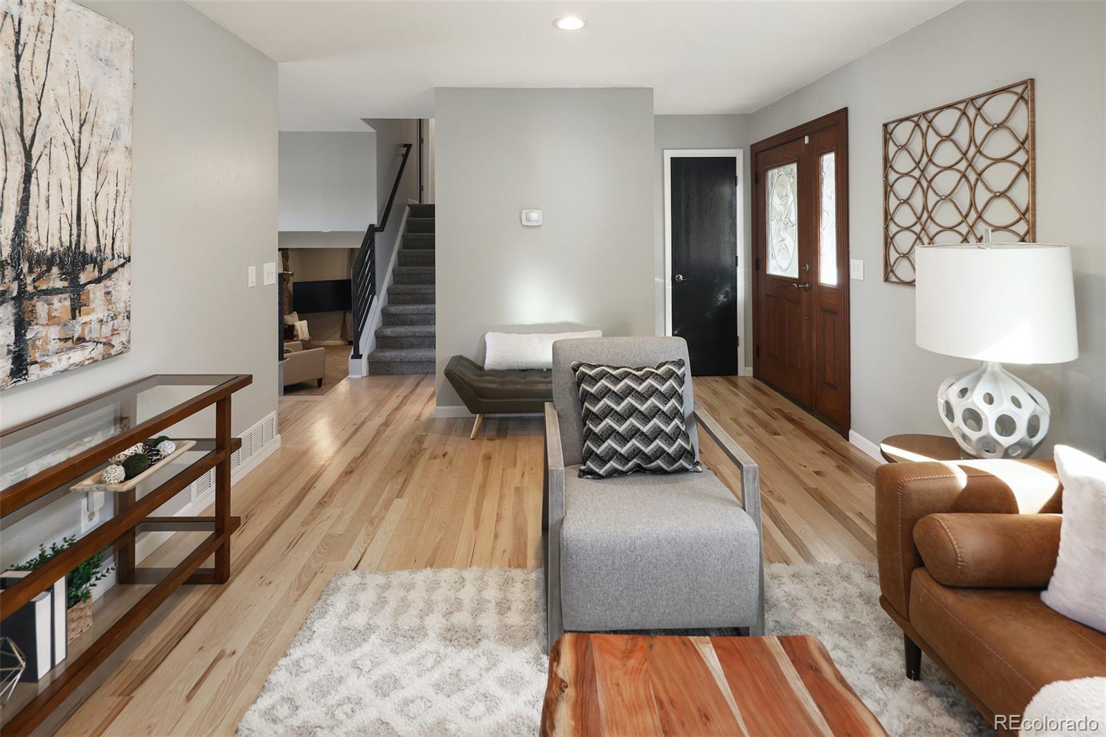 10499 Newcombe Street Westminster, CO 80021 - Photo 7 of 33 a living room with furniture and wooden floor