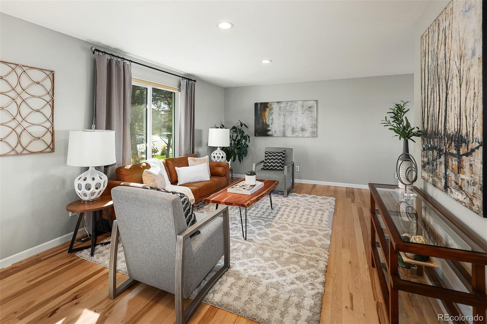 10499 Newcombe Street Westminster, CO 80021 - Photo 8 of 33 a living room with furniture and a potted plant
