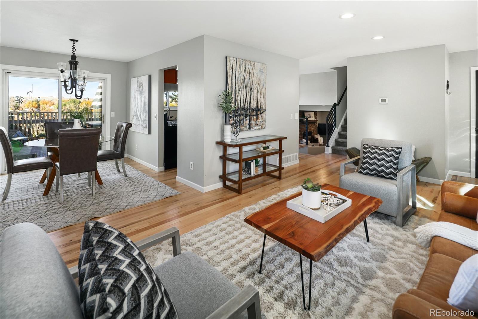 10499 Newcombe Street Westminster, CO 80021 - Photo 10 of 33 a living room with furniture and a dining table