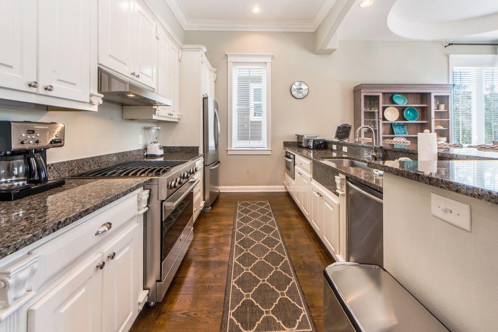93 Gulfview Circle Santa Rosa Beach, FL 32459 - Photo 17 of 55 a kitchen with stainless steel appliances granite countertop a stove and a sink
