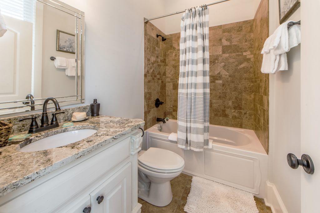 93 Gulfview Circle Santa Rosa Beach, FL 32459 - Photo 36 of 55 a bathroom with a granite countertop sink toilet a mirror and shower