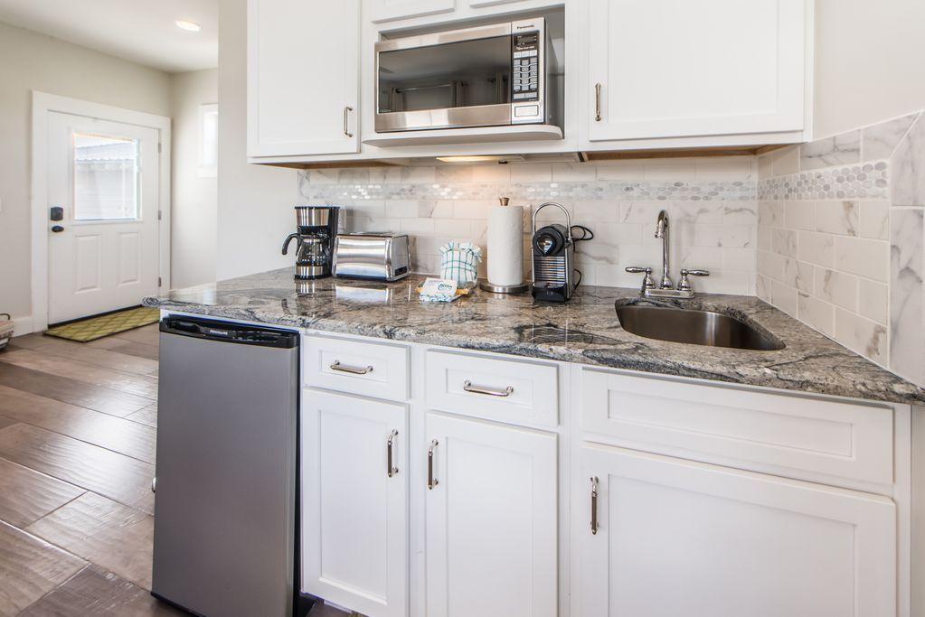 93 Gulfview Circle Santa Rosa Beach, FL 32459 - Photo 45 of 55 a kitchen with granite countertop white cabinets and white appliances
