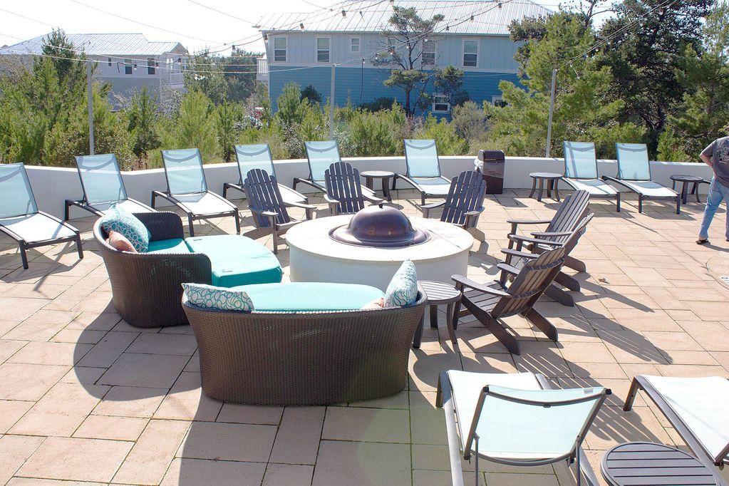 93 Gulfview Circle Santa Rosa Beach, FL 32459 - Photo 51 of 55 a view of a patio with table and chairs couches with wooden floor and fence