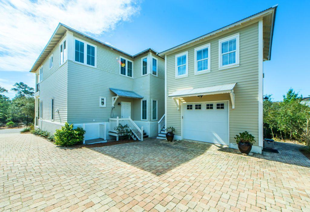 93 Gulfview Circle Santa Rosa Beach, FL 32459 - Photo 8 of 55 a front view of a house with a yard and potted plants