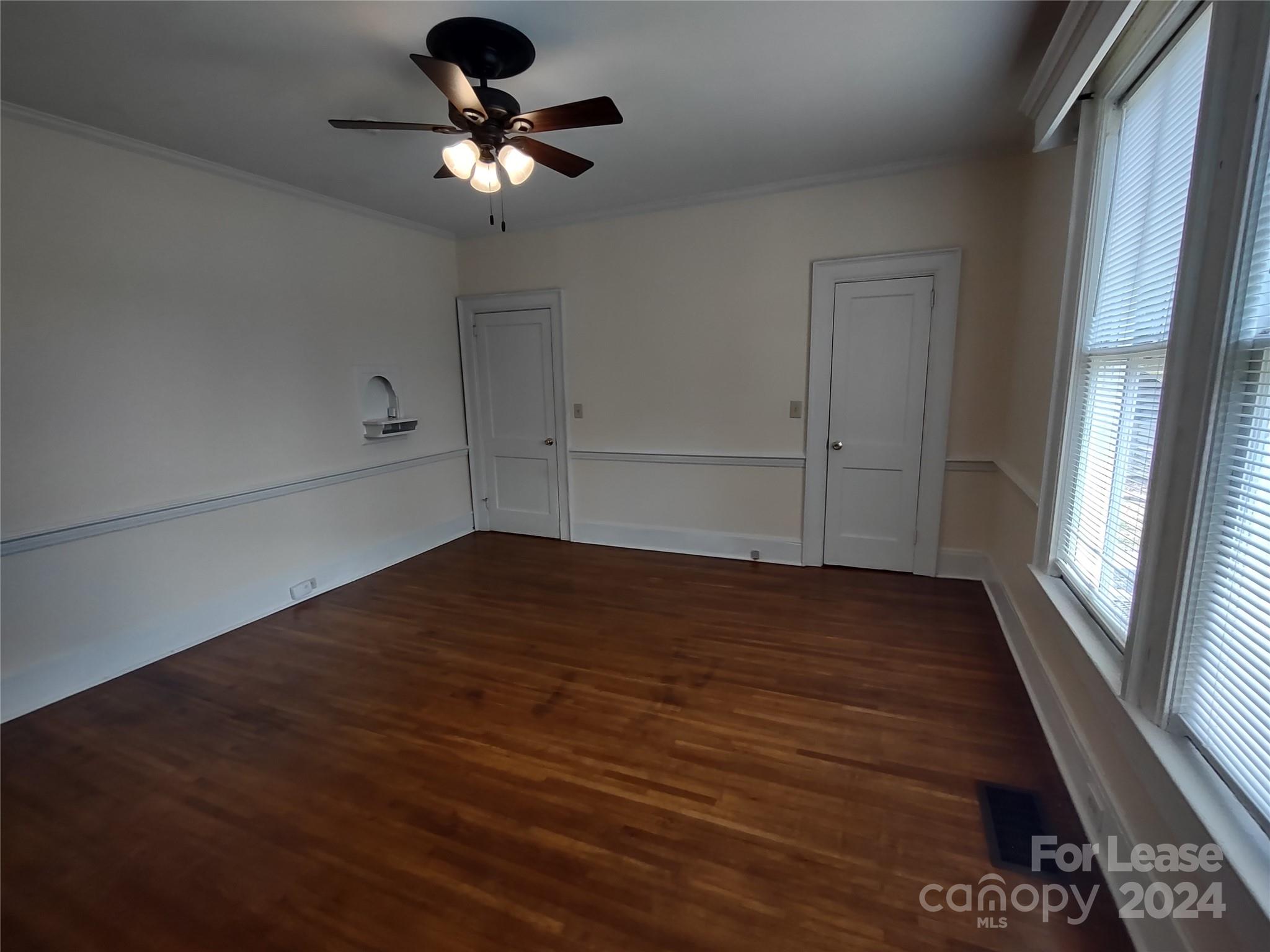 476 Spring Street Southwest Concord, NC 28025 - Photo 5 of 12 a view of empty room with wooden floor and fan