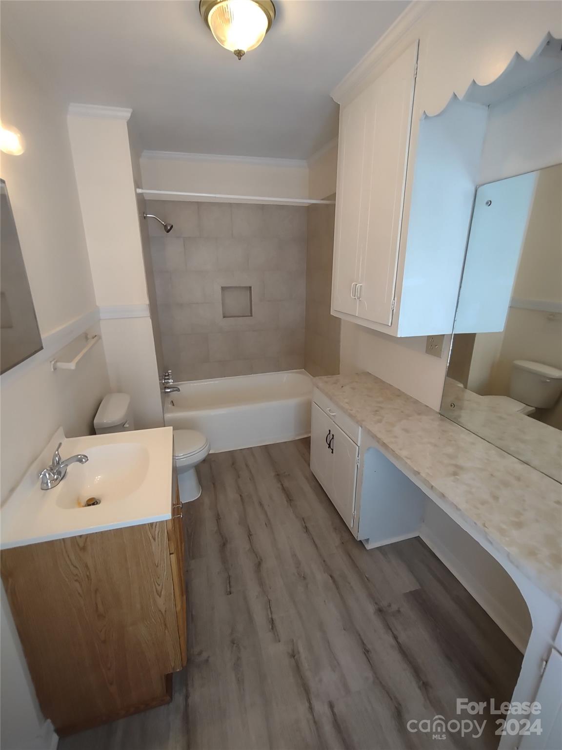 476 Spring Street Southwest Concord, NC 28025 - Photo 7 of 12 a bathroom with a granite countertop sink a toilet and bathtub