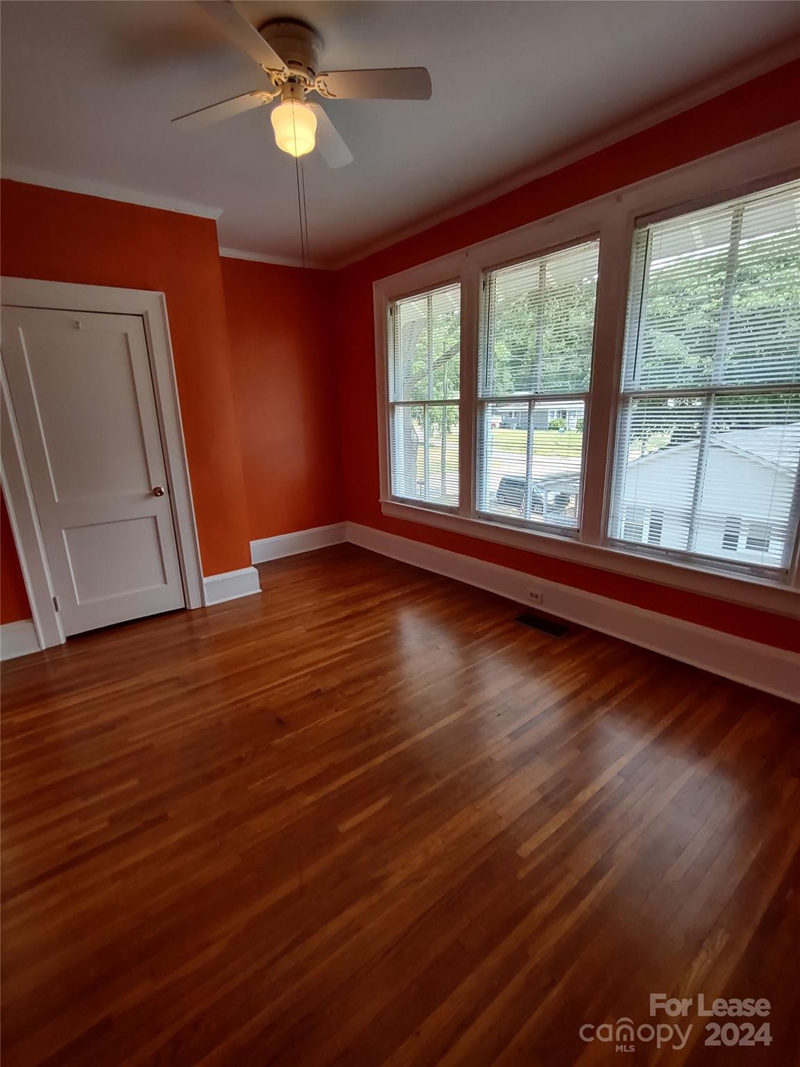 476 Spring Street Southwest Concord, NC 28025 - Photo 10 of 12 a view of room with wooden floor and fan