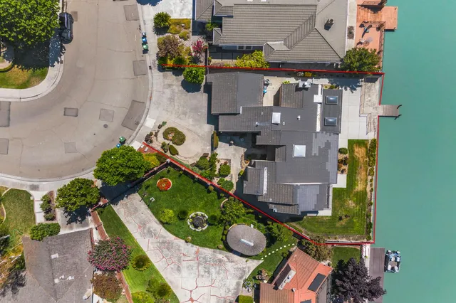 an aerial view of residential house with yard and swimming pool