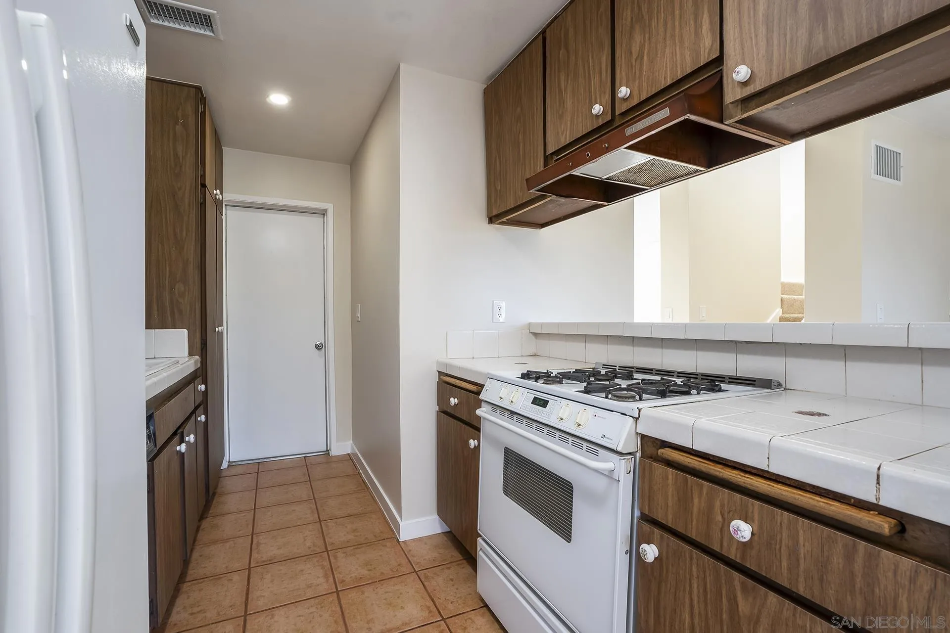 2014 Terraspiro Avenue Spring Valley, CA 91977 - Photo 12 of 28 a kitchen with a stove top oven and cabinets