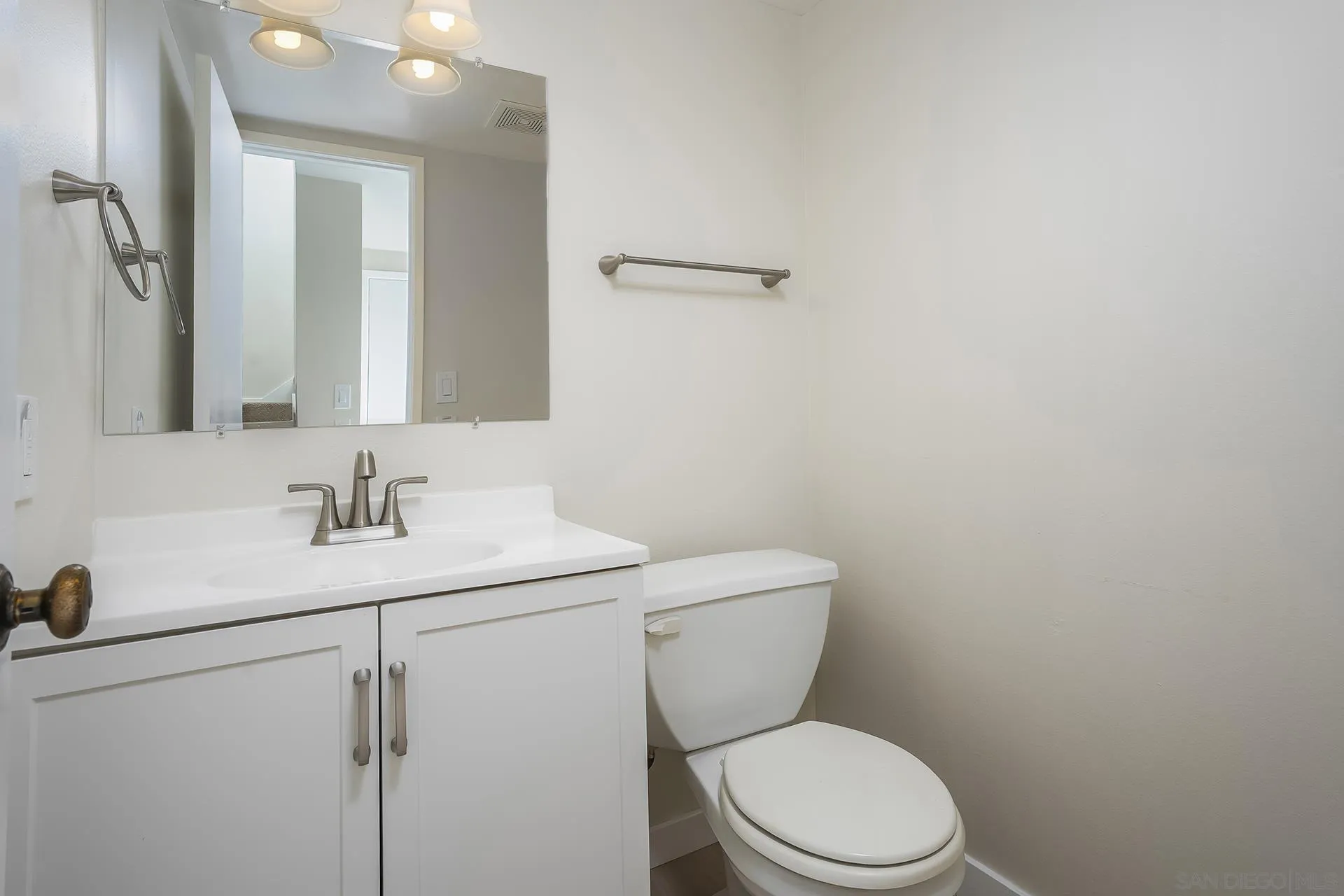 2014 Terraspiro Avenue Spring Valley, CA 91977 - Photo 13 of 28 a bathroom with a toilet a sink and mirror