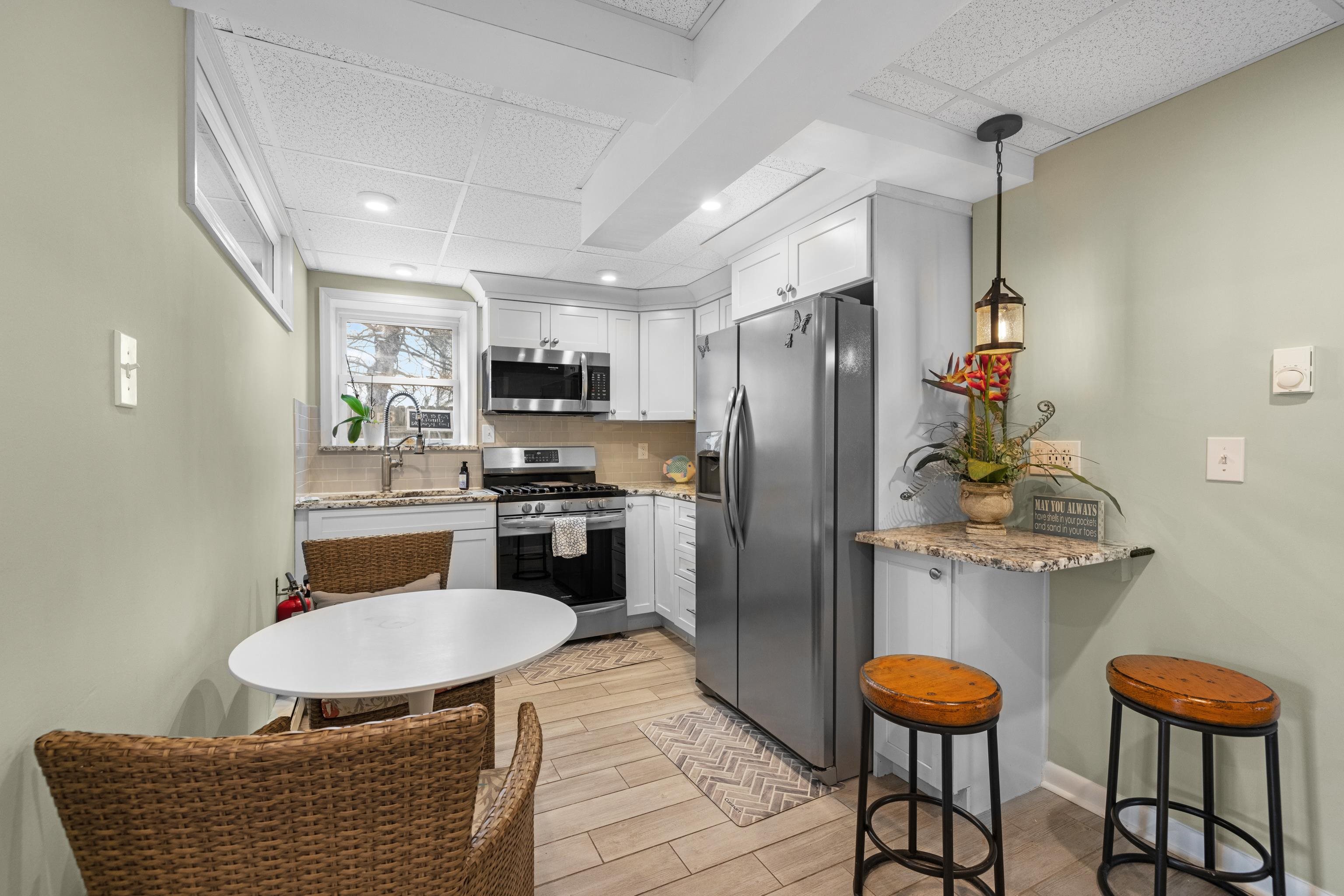 511 Forest Cape Villas, NJ 08251 - Photo 24 of 48 a kitchen with stainless steel appliances granite countertop a sink refrigerator and stove