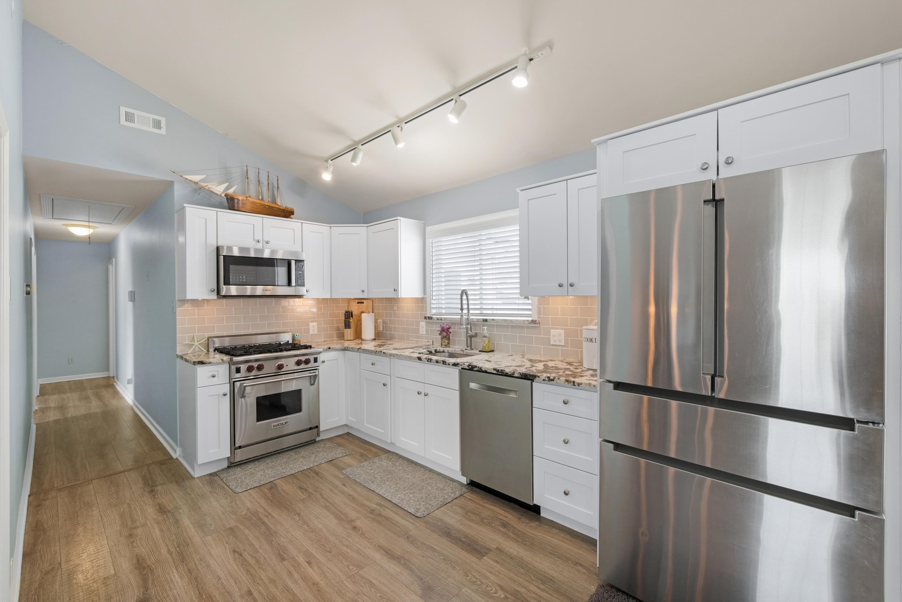 511 Forest Cape Villas, NJ 08251 - Photo 9 of 48 a kitchen with stainless steel appliances granite countertop a refrigerator stove a sink and a microwave