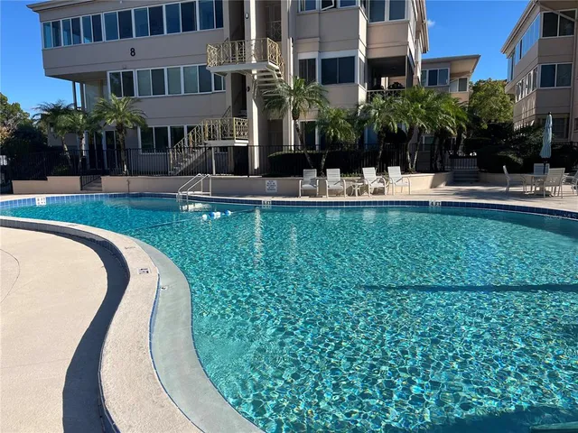 a view of a patio with couches table and chairs and potted plants