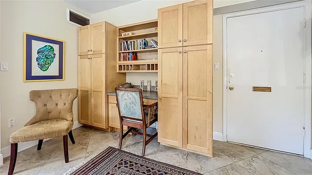 a living room with furniture a rug and a window