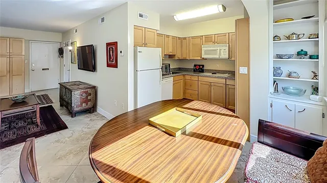 a kitchen with stainless steel appliances granite countertop white cabinets sink and a granite counter top