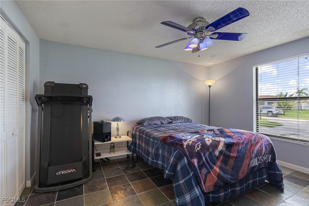 4496 31st Avenue Southwest Naples, FL 34116 - Photo 14 of 26 a bedroom with a bed and window