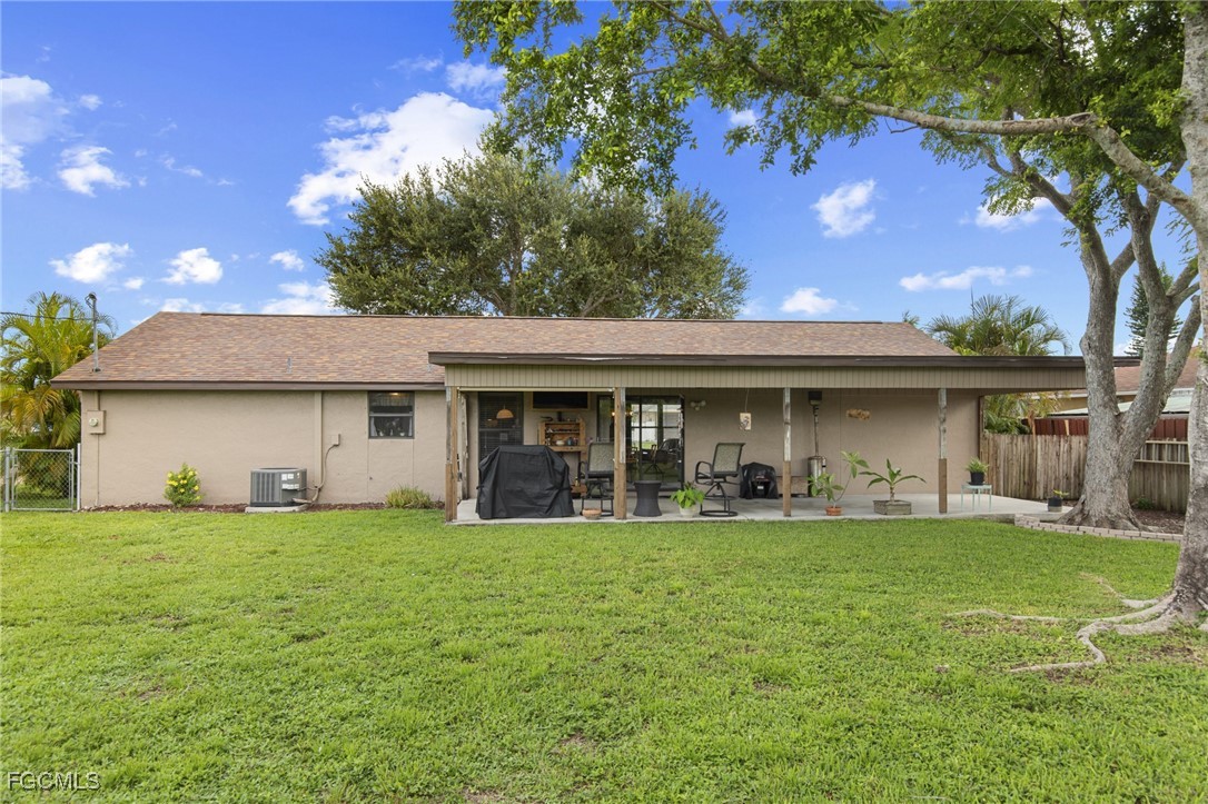 4496 31st Avenue Southwest Naples, FL 34116 - Photo 18 of 26 a view of a house with a yard and a large tree