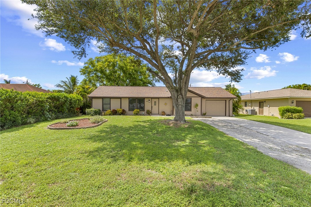 4496 31st Avenue Southwest Naples, FL 34116 - Photo 21 of 26 a view of a house with backyard and a tree