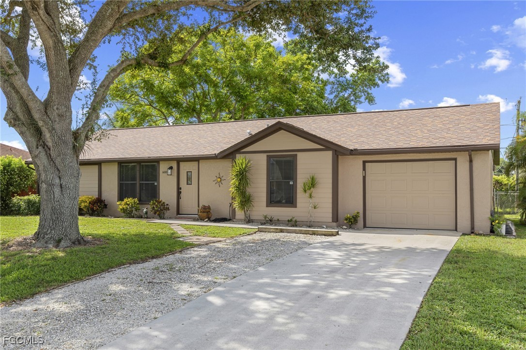 4496 31st Avenue Southwest Naples, FL 34116 - Photo 22 of 26 a front view of a house with a garden
