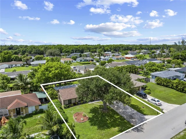 an aerial view of a residential houses with outdoor space and street view