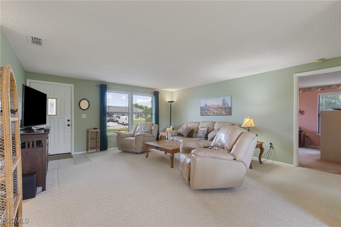 4496 31st Avenue Southwest Naples, FL 34116 - Photo 4 of 26 a living room with furniture and a flat screen tv