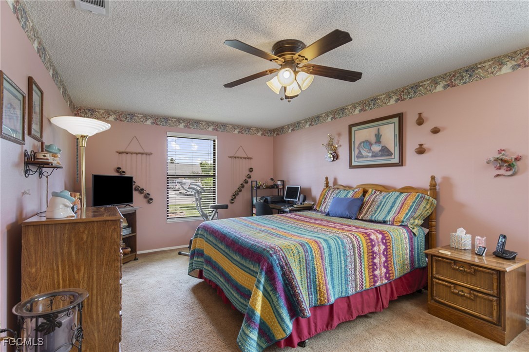 4496 31st Avenue Southwest Naples, FL 34116 - Photo 10 of 26 a bedroom with a bed and a flat screen tv