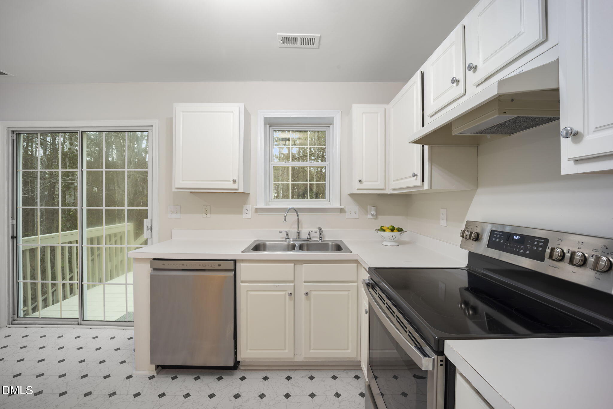 900 Spring Meadow Drive Durham, NC 27713 - Photo 11 of 26 a kitchen with cabinets appliances a sink and a window