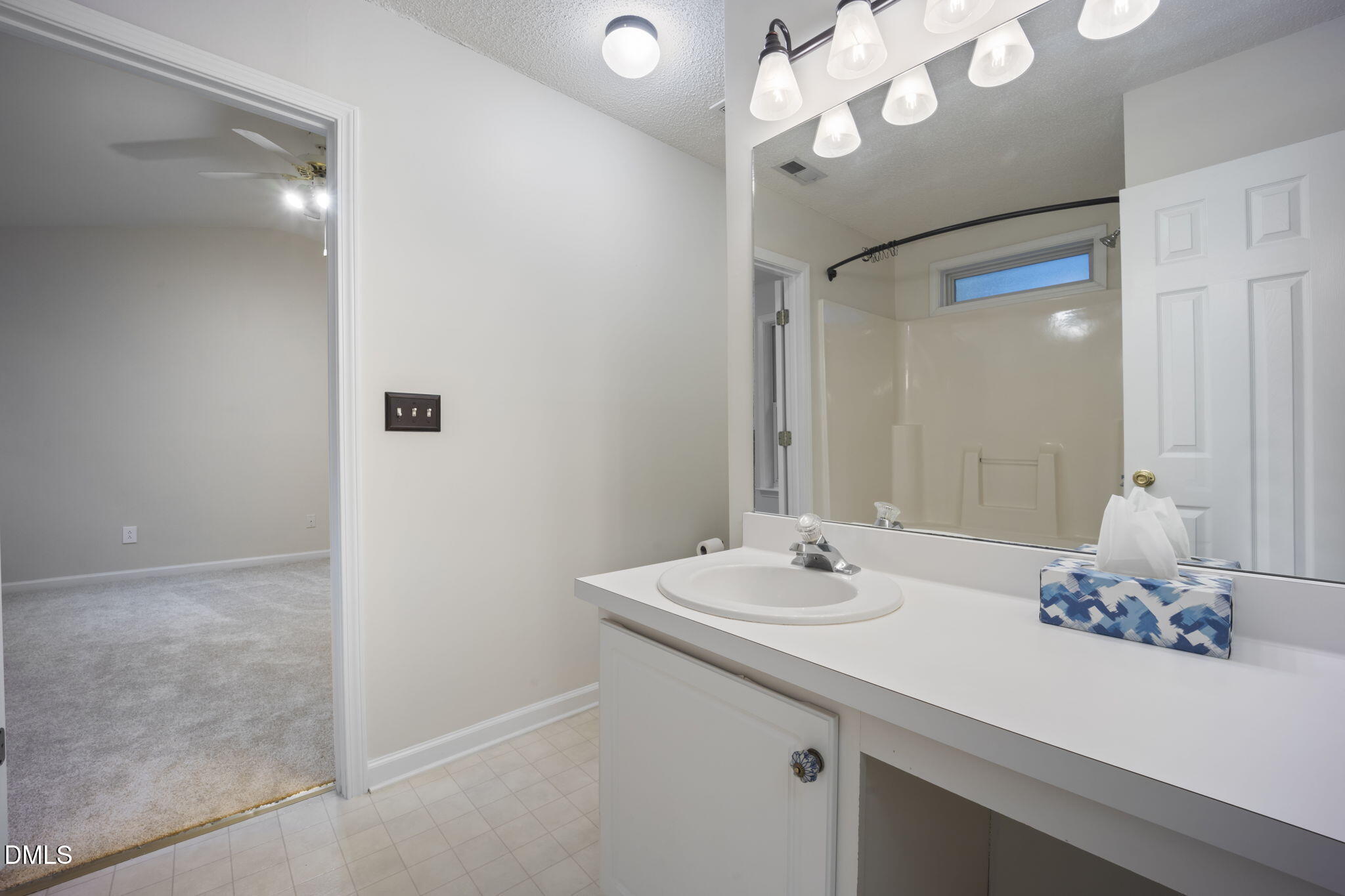 900 Spring Meadow Drive Durham, NC 27713 - Photo 18 of 26 a bathroom with a sink a large mirror and a shower
