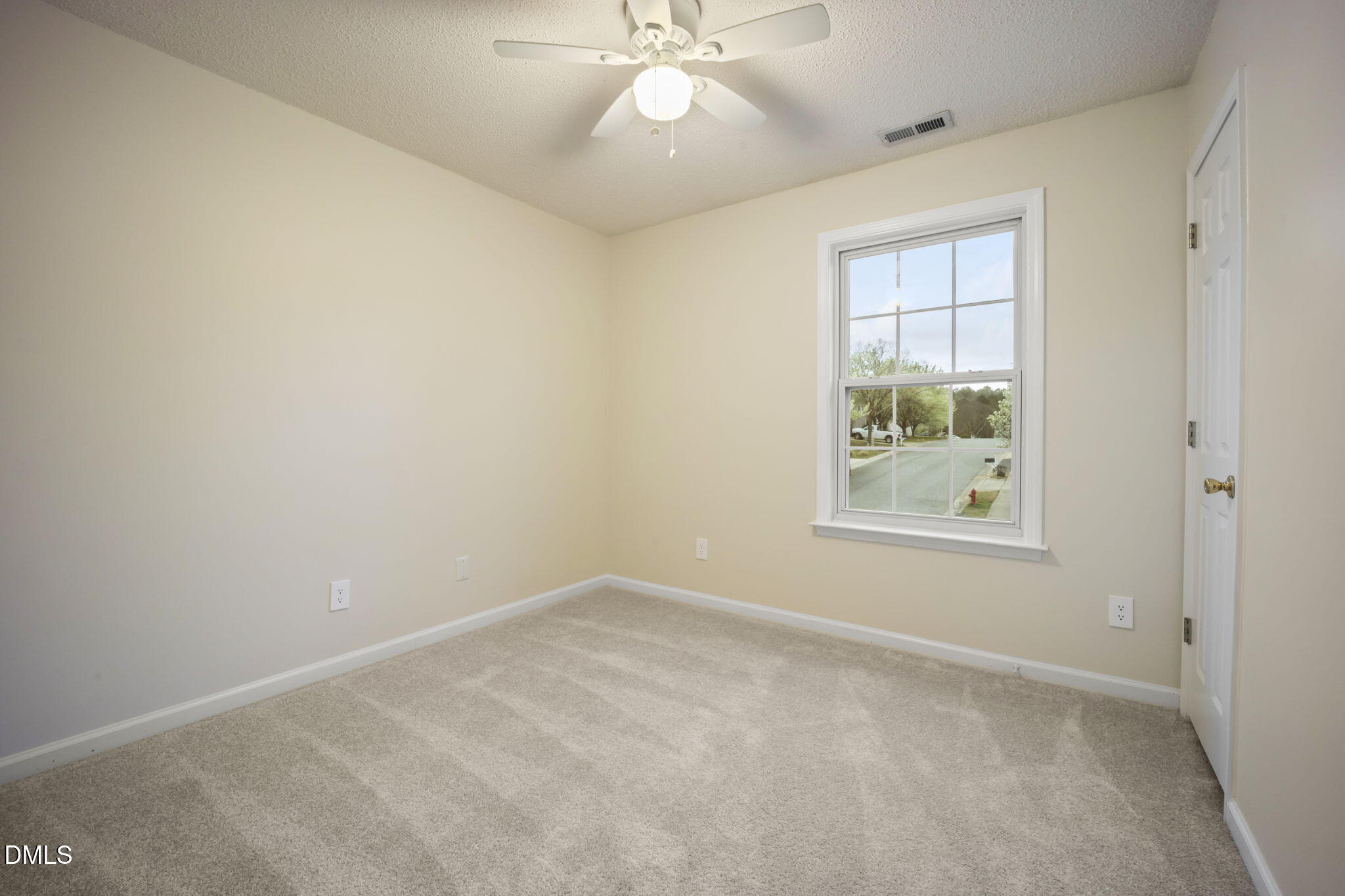 900 Spring Meadow Drive Durham, NC 27713 - Photo 19 of 26 an empty room with windows and fan