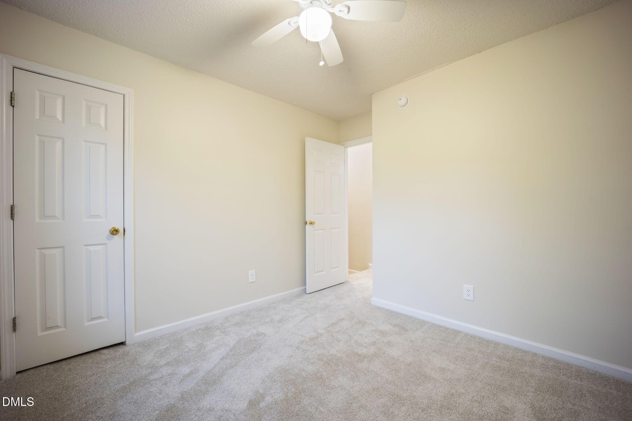 900 Spring Meadow Drive Durham, NC 27713 - Photo 20 of 26 an empty room with a ceiling fan