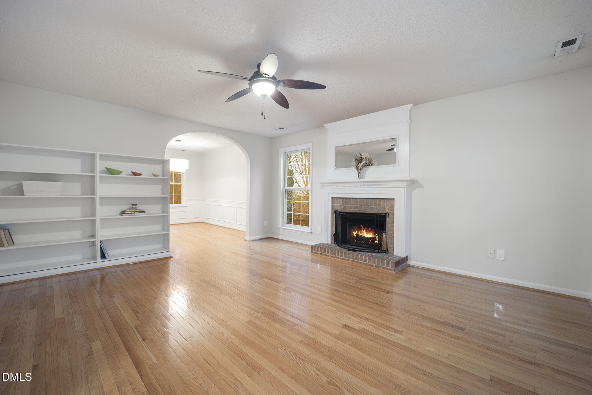 900 Spring Meadow Drive Durham, NC 27713 - Photo 2 of 26 a view of an empty room with a fireplace and a window