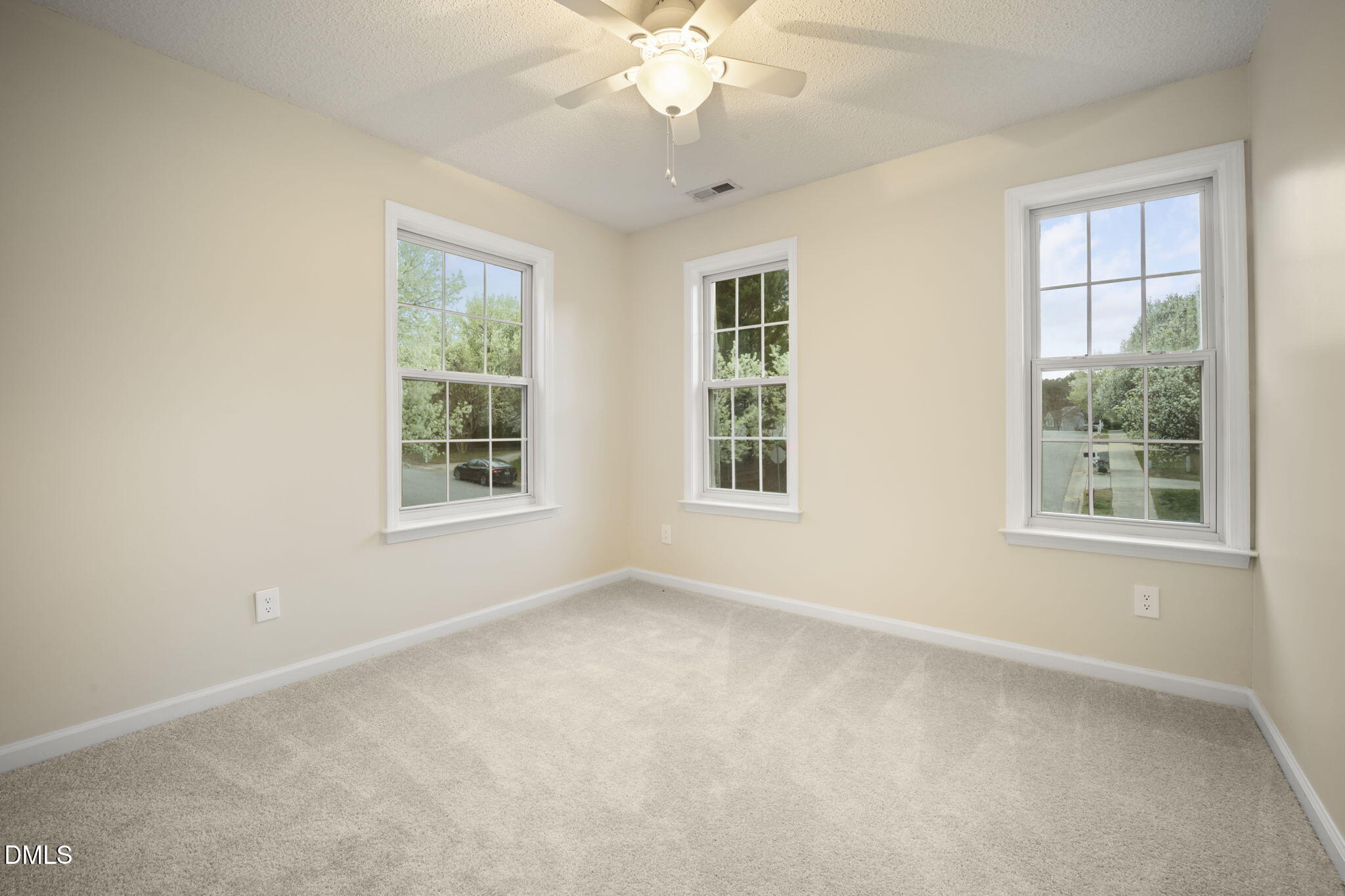 900 Spring Meadow Drive Durham, NC 27713 - Photo 21 of 26 an empty room with chandelier fan and windows