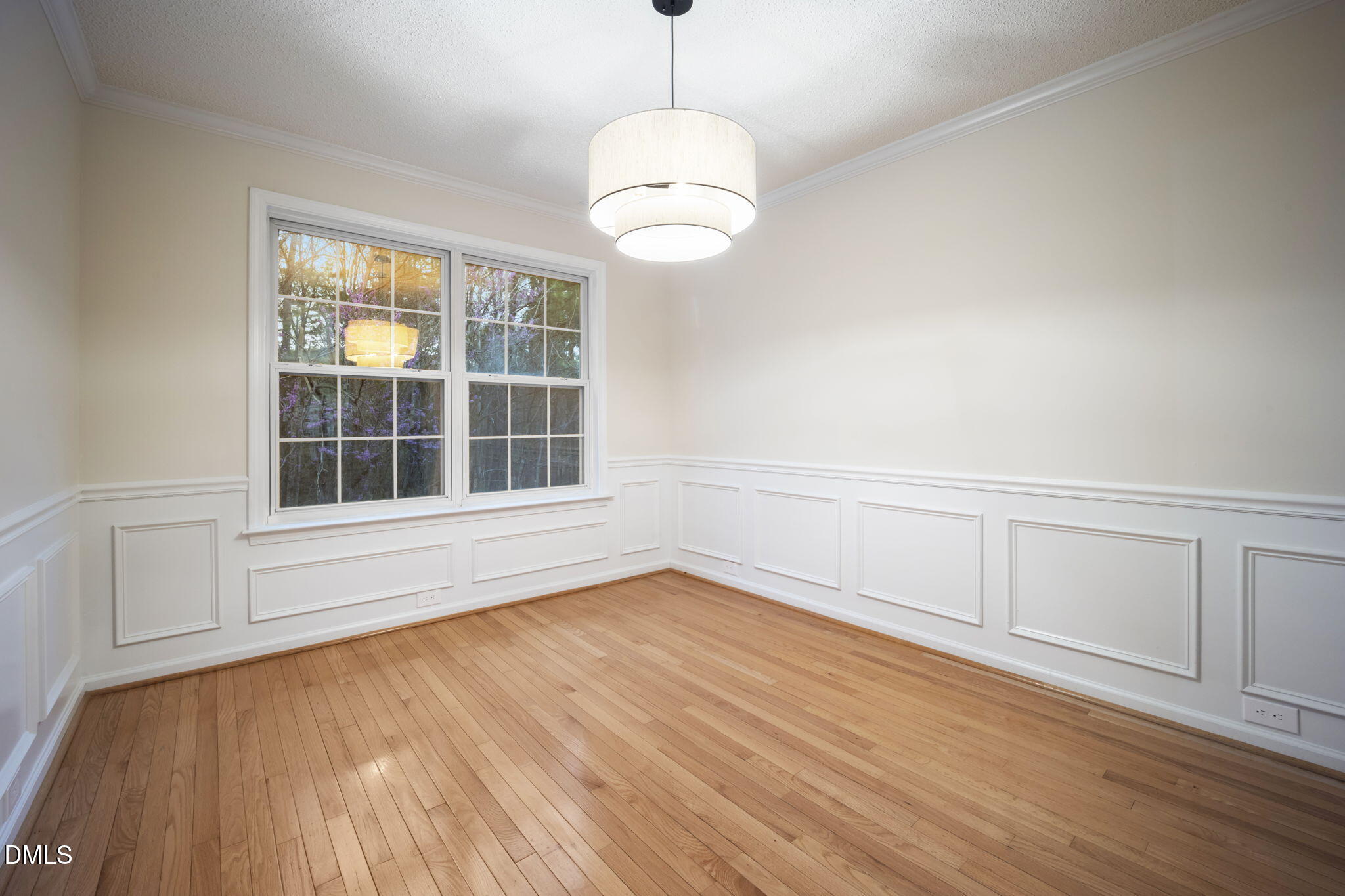 900 Spring Meadow Drive Durham, NC 27713 - Photo 6 of 26 an empty room with wooden floor and windows