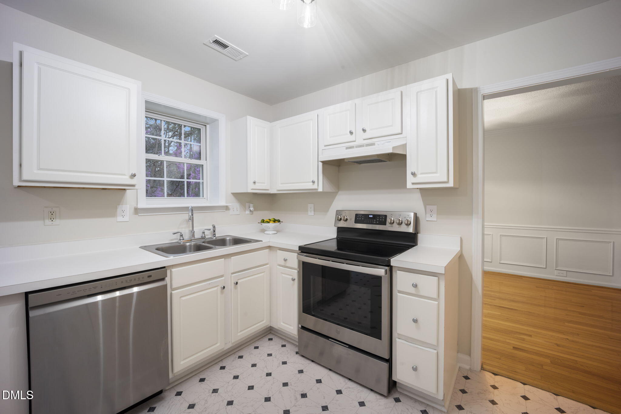 900 Spring Meadow Drive Durham, NC 27713 - Photo 8 of 26 a kitchen with granite countertop a sink stove and cabinets