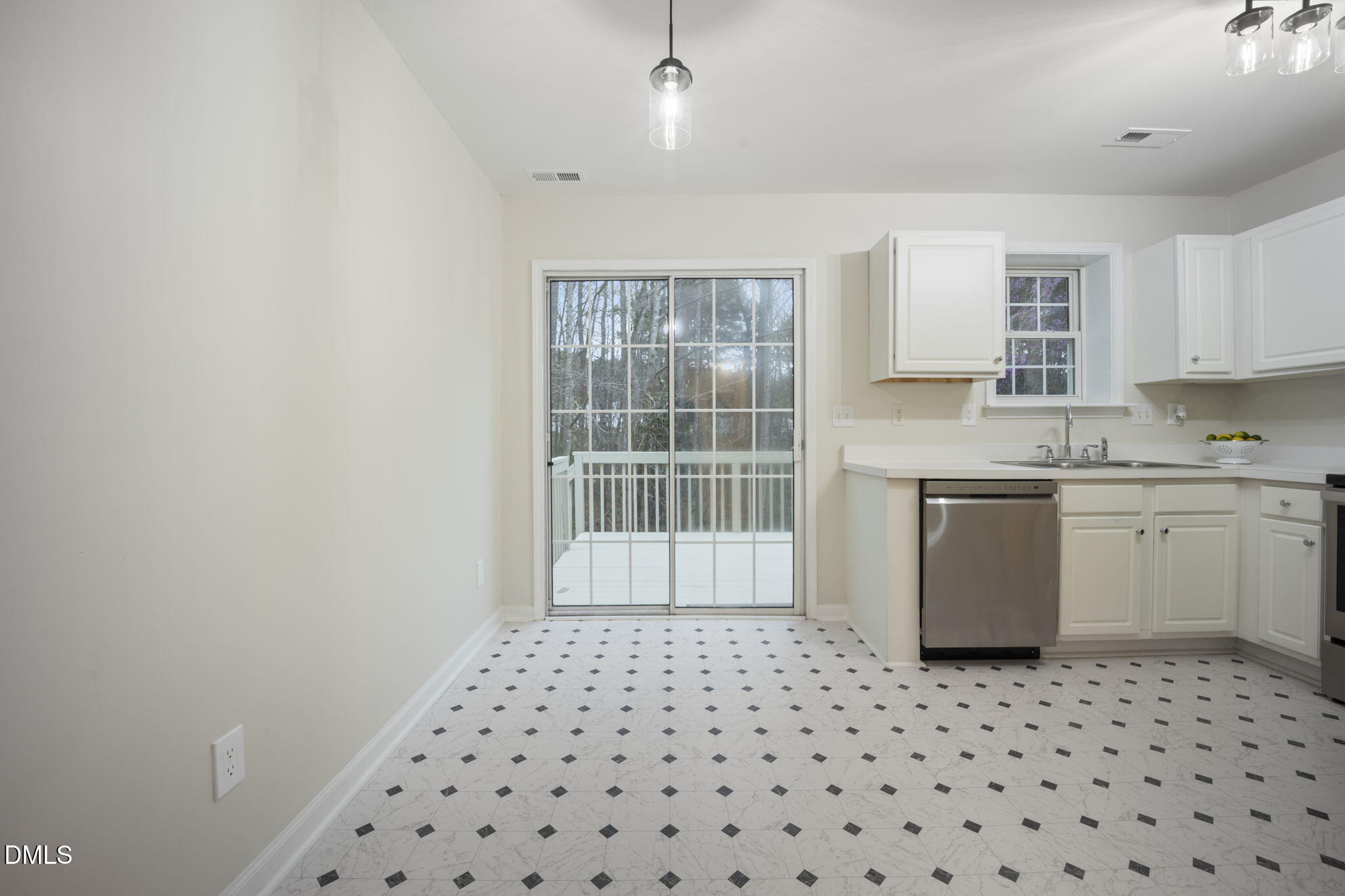 900 Spring Meadow Drive Durham, NC 27713 - Photo 9 of 26 a kitchen with a sink a stove cabinets and a window