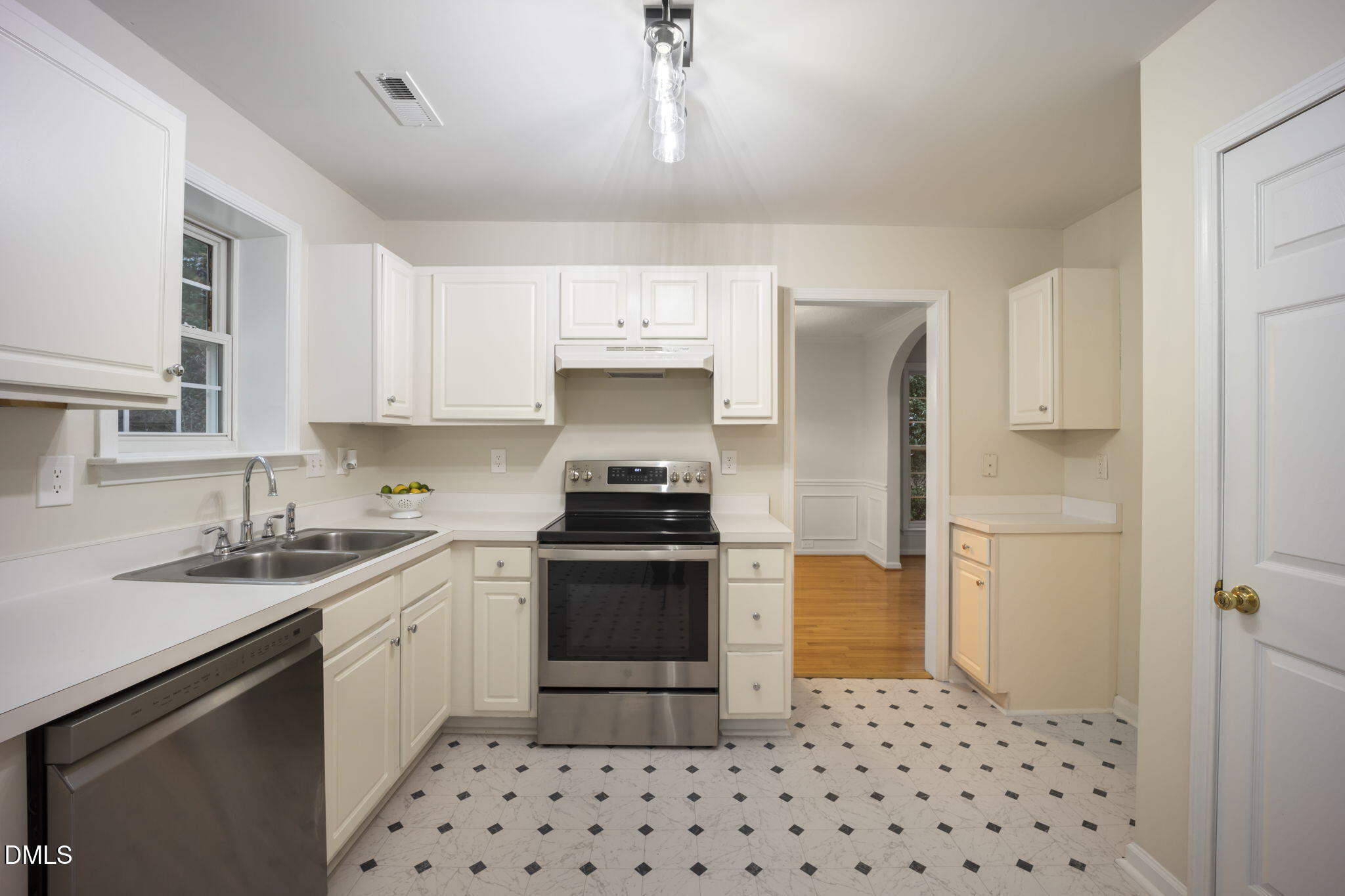 900 Spring Meadow Drive Durham, NC 27713 - Photo 10 of 26 a kitchen with a sink a stove and refrigerator