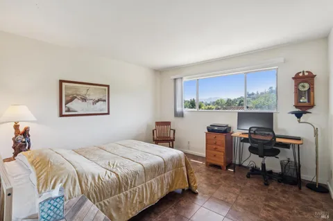 a bedroom with a bed a desk and chair