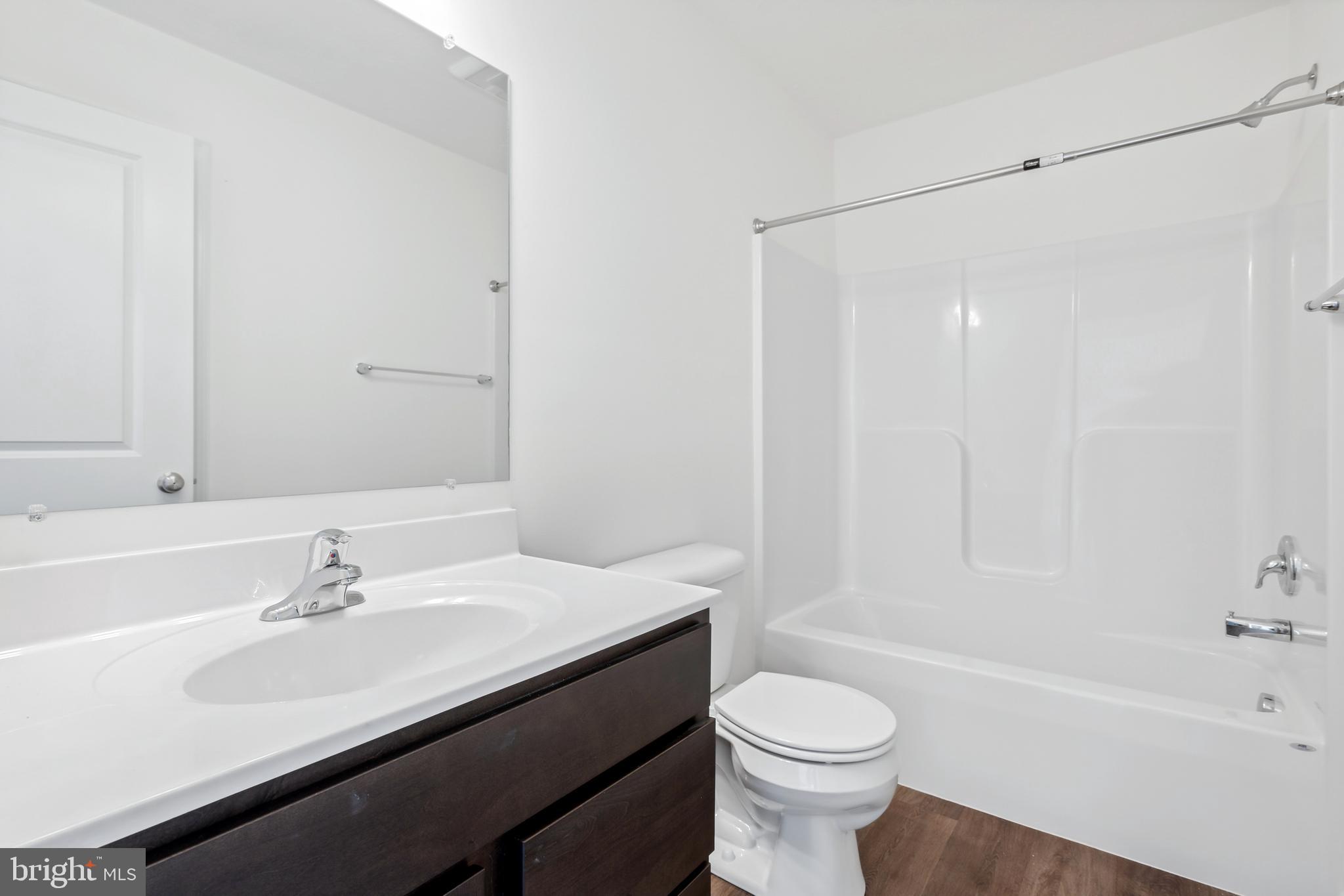 170 Piedmont Way, Unit 98 Hanover, PA 17331 - Photo 20 of 23 a bathroom with a sink a toilet and a bathtub