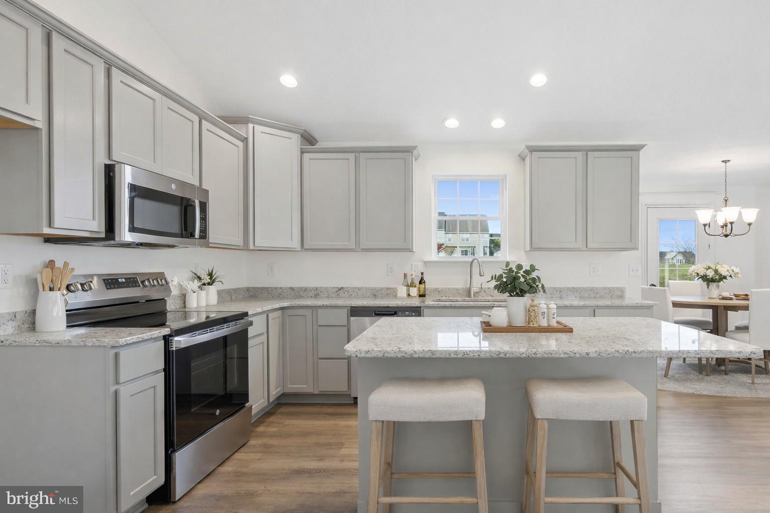 170 Piedmont Way, Unit 98 Hanover, PA 17331 - Photo 2 of 23 a kitchen with kitchen island granite countertop a sink and stove top oven